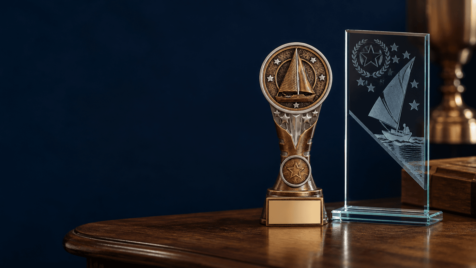 Bronze and glass sailing trophies displayed in a heritage workshop