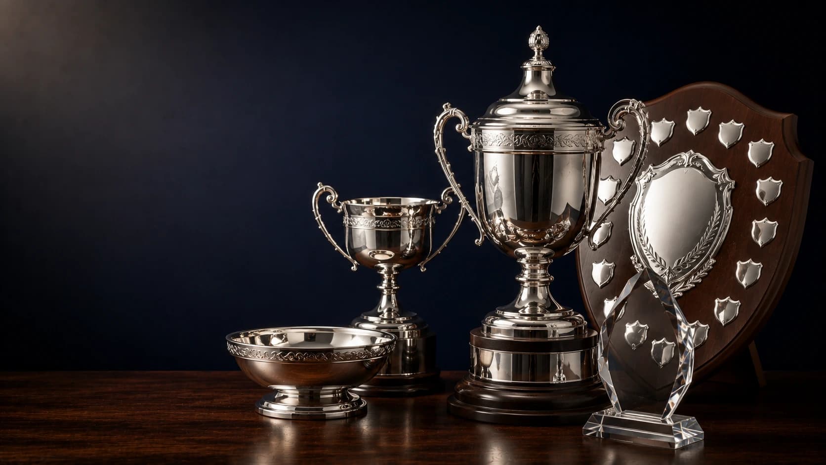 Sports trophies, presentation shield and crystal award arranged for club awards
