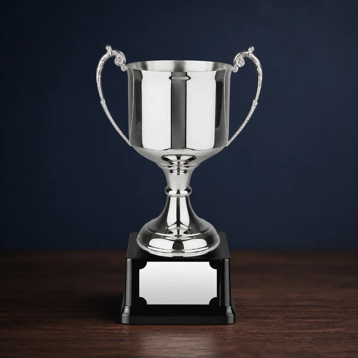 Compact silver cup on a dark presentation base