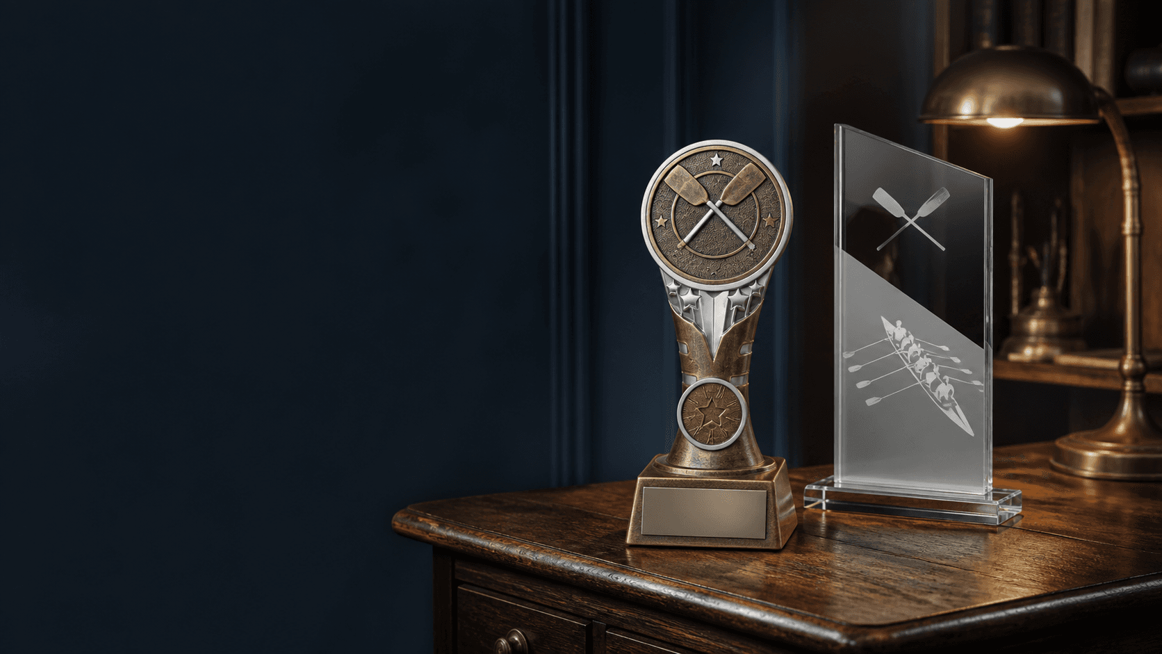 Bronze and glass rowing trophies displayed in a heritage workshop